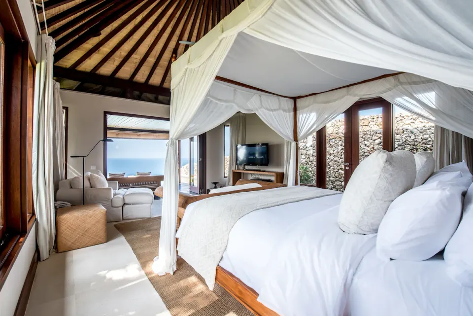 A bright ocean-view bedroom at The Ungasan Clifftop Resort