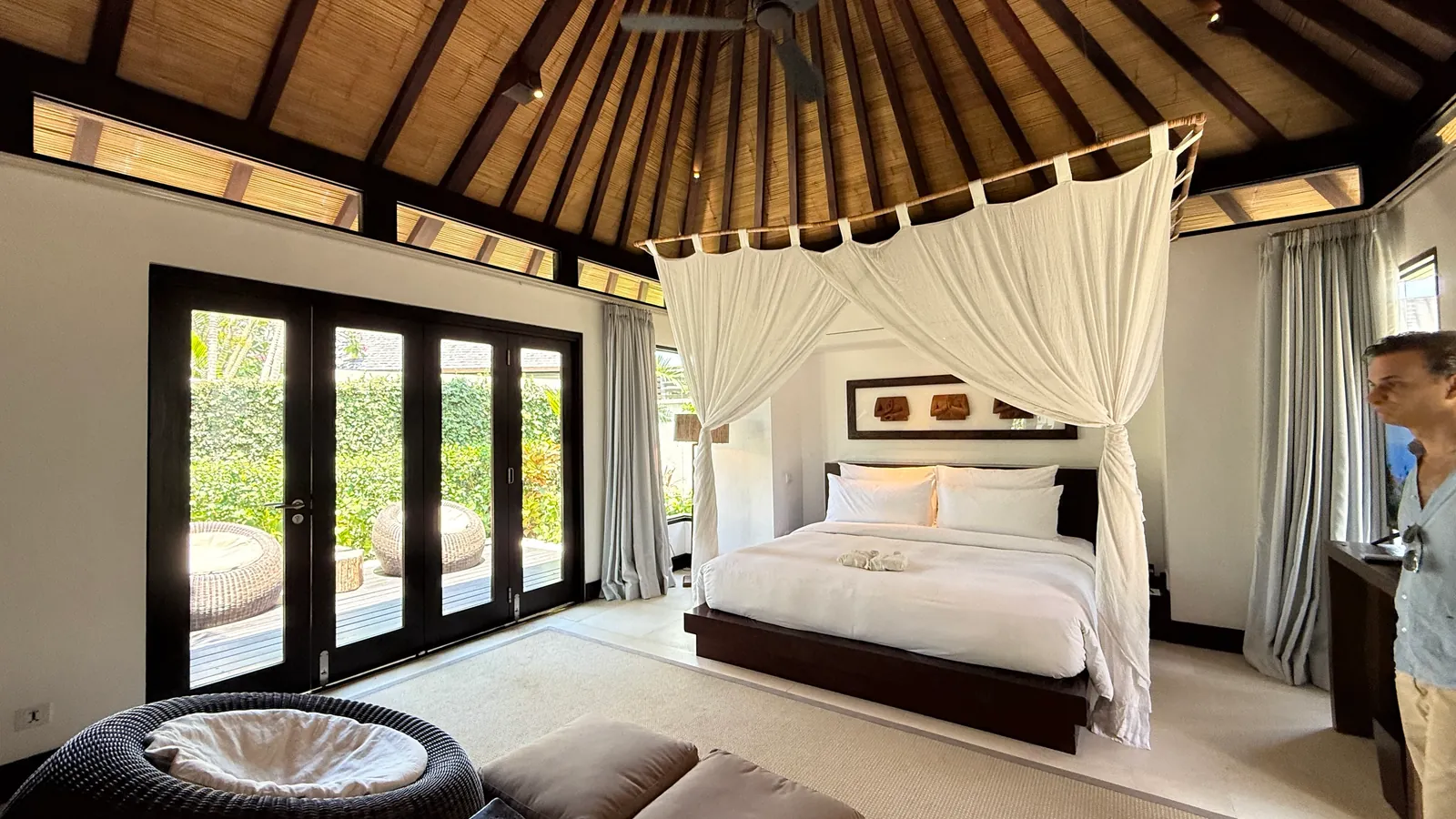 Villa bedroom with a canopy bed and garden terrace at The Ungasan