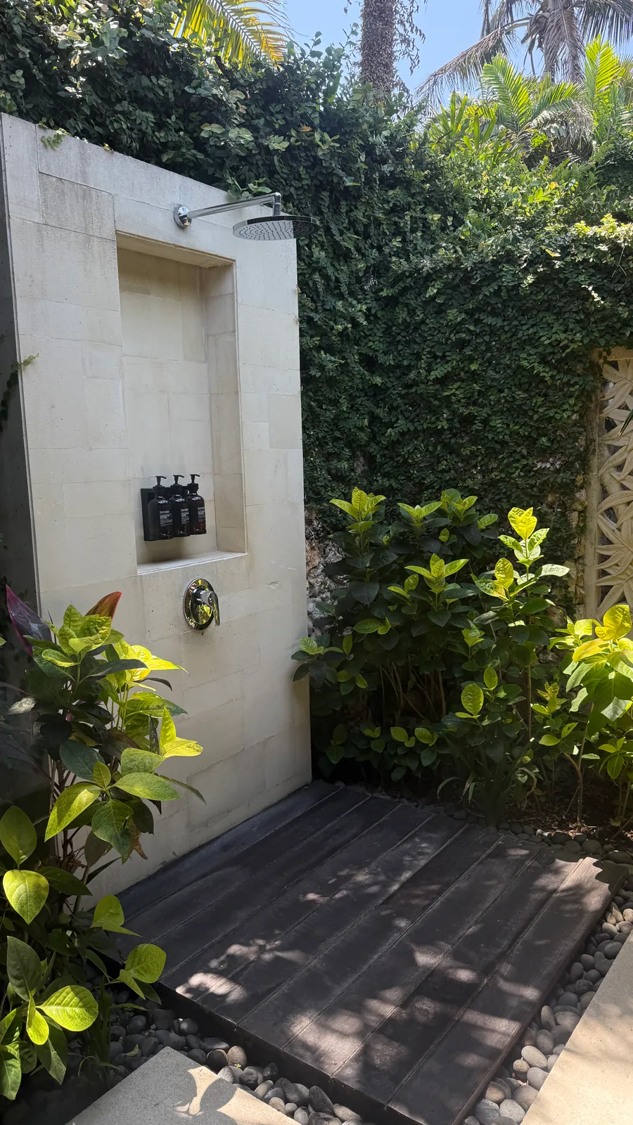 Outdoor rain shower surrounded by tropical greenery at The Ungasan