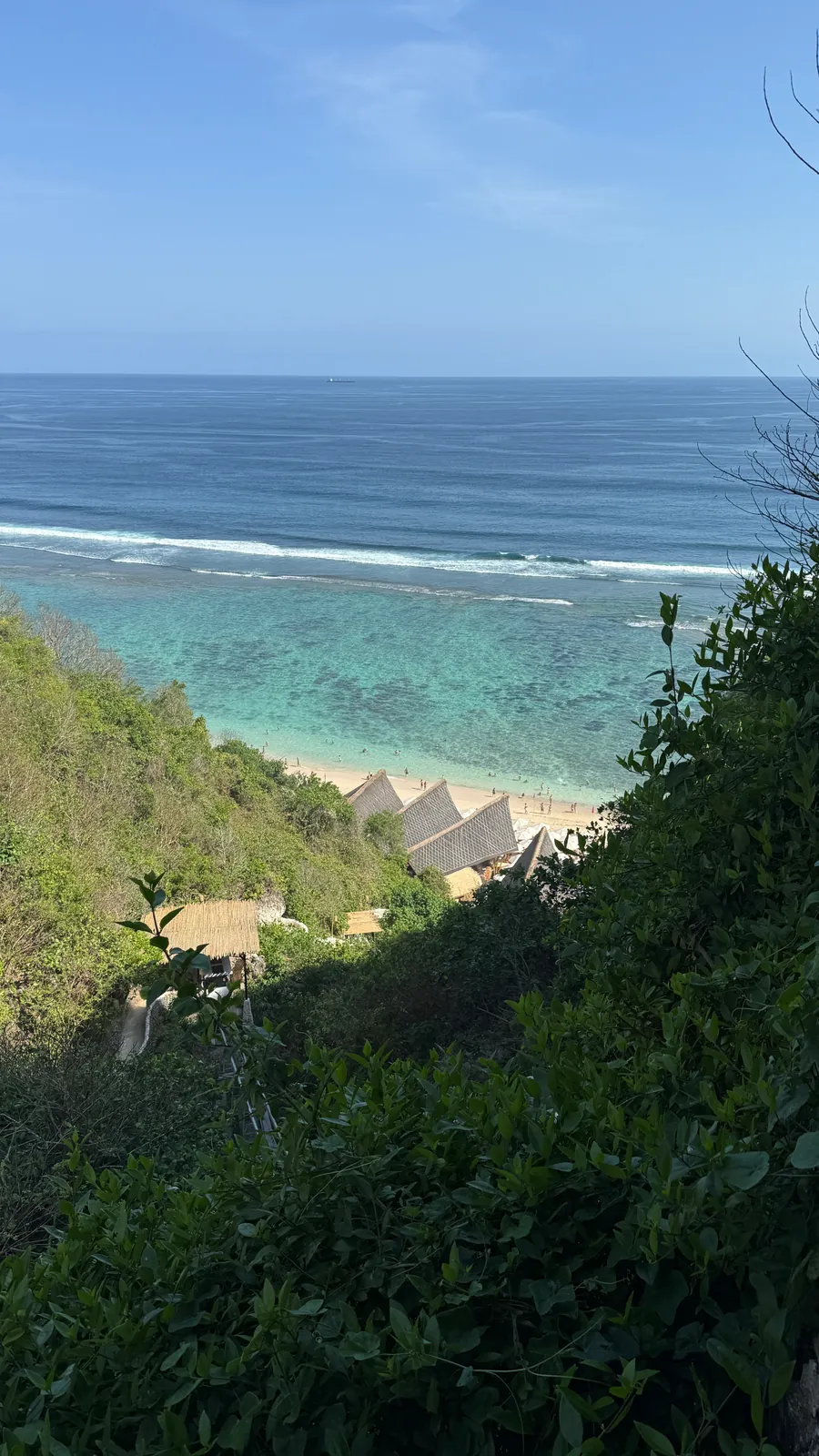 Turquoise ocean and beach below the cliffs at The Ungasan